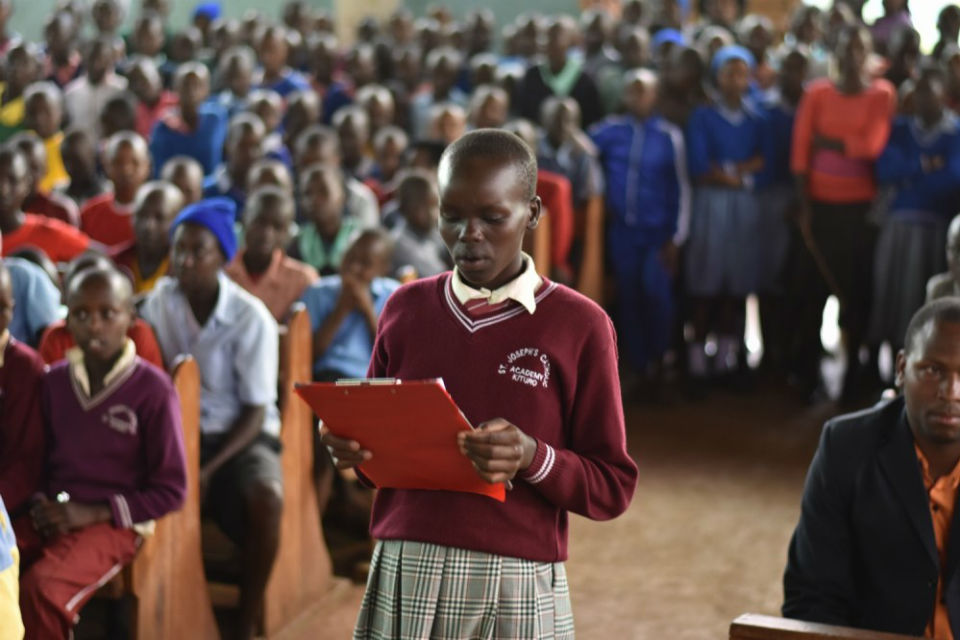 Sponsored girl addressing visitors from a Baylor University Men