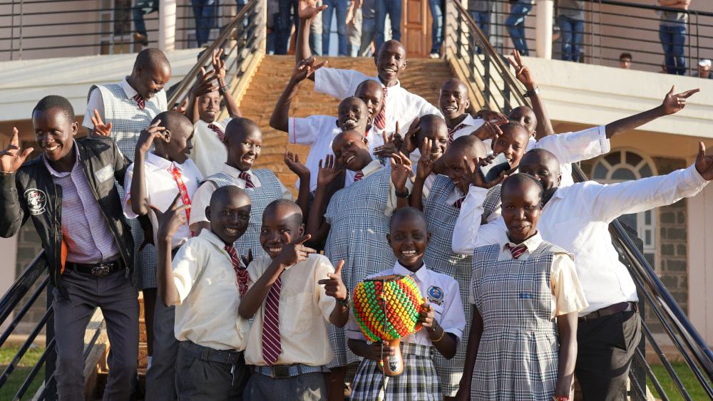 Sponsored students posing with their teachers at St. Josephs School